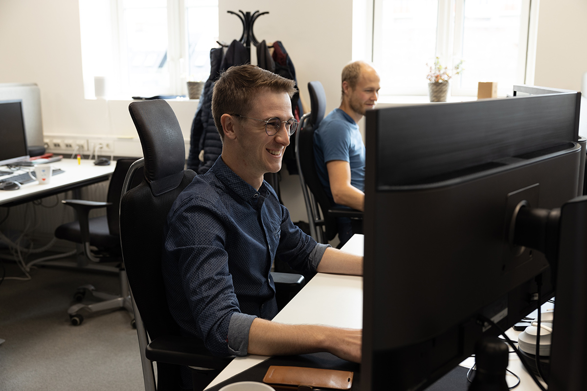 Colleagues working at their desks in the Level K6 office